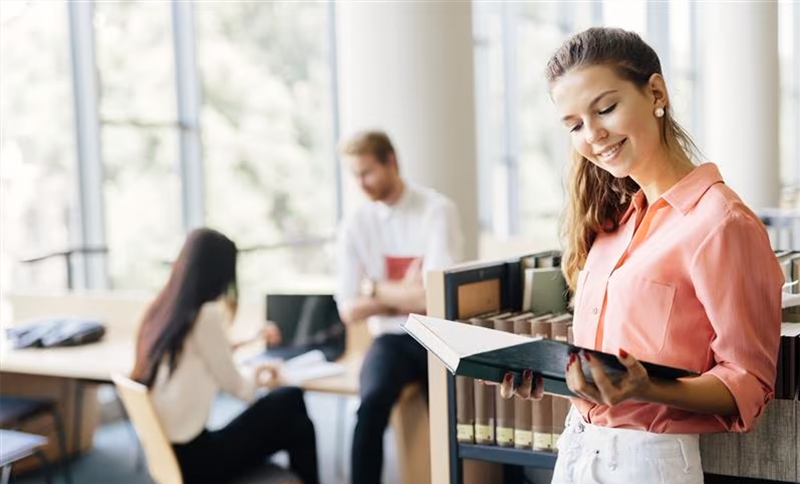 Law student at laptop with piggy bank