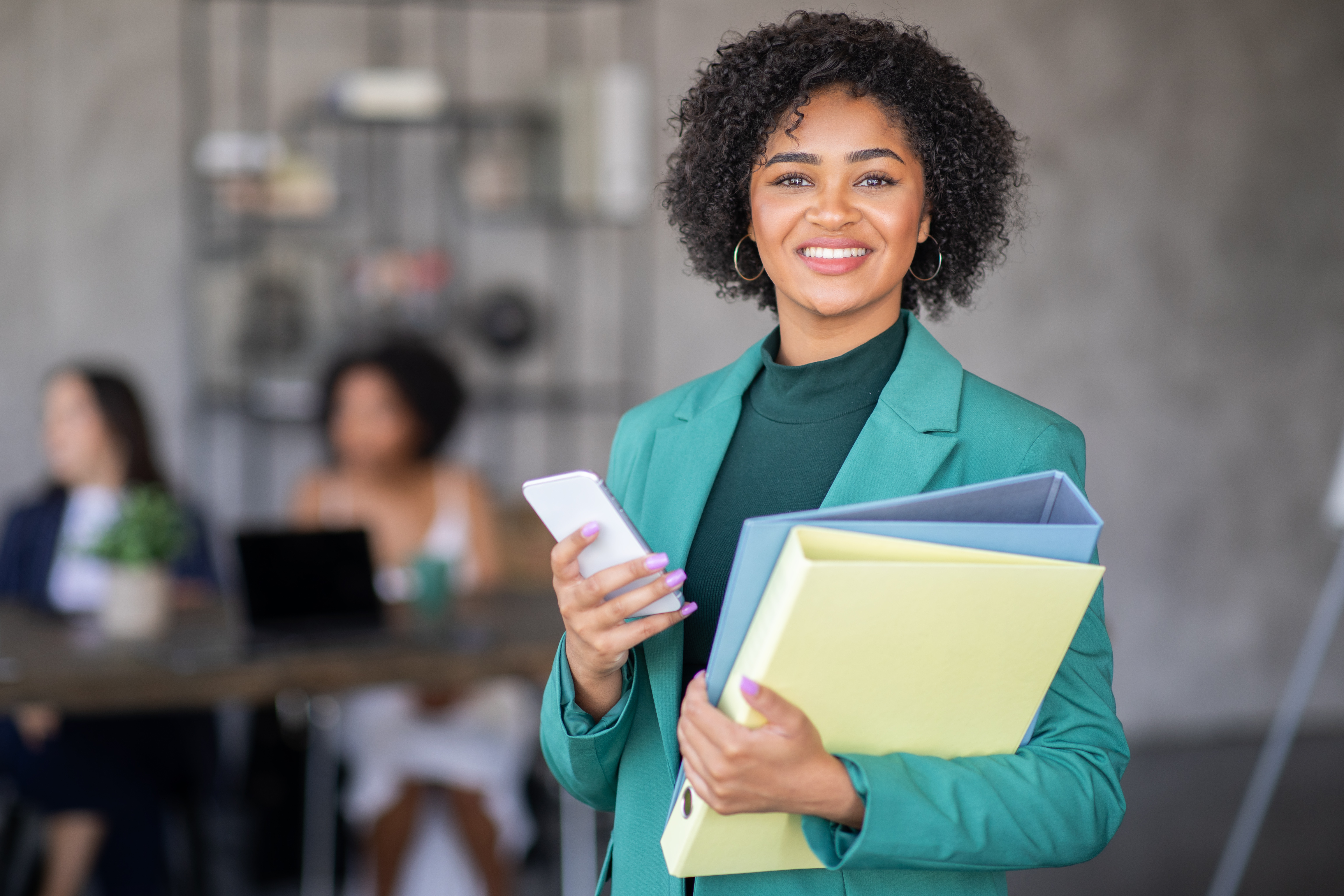 Legal professional holding binders and mobile phone
