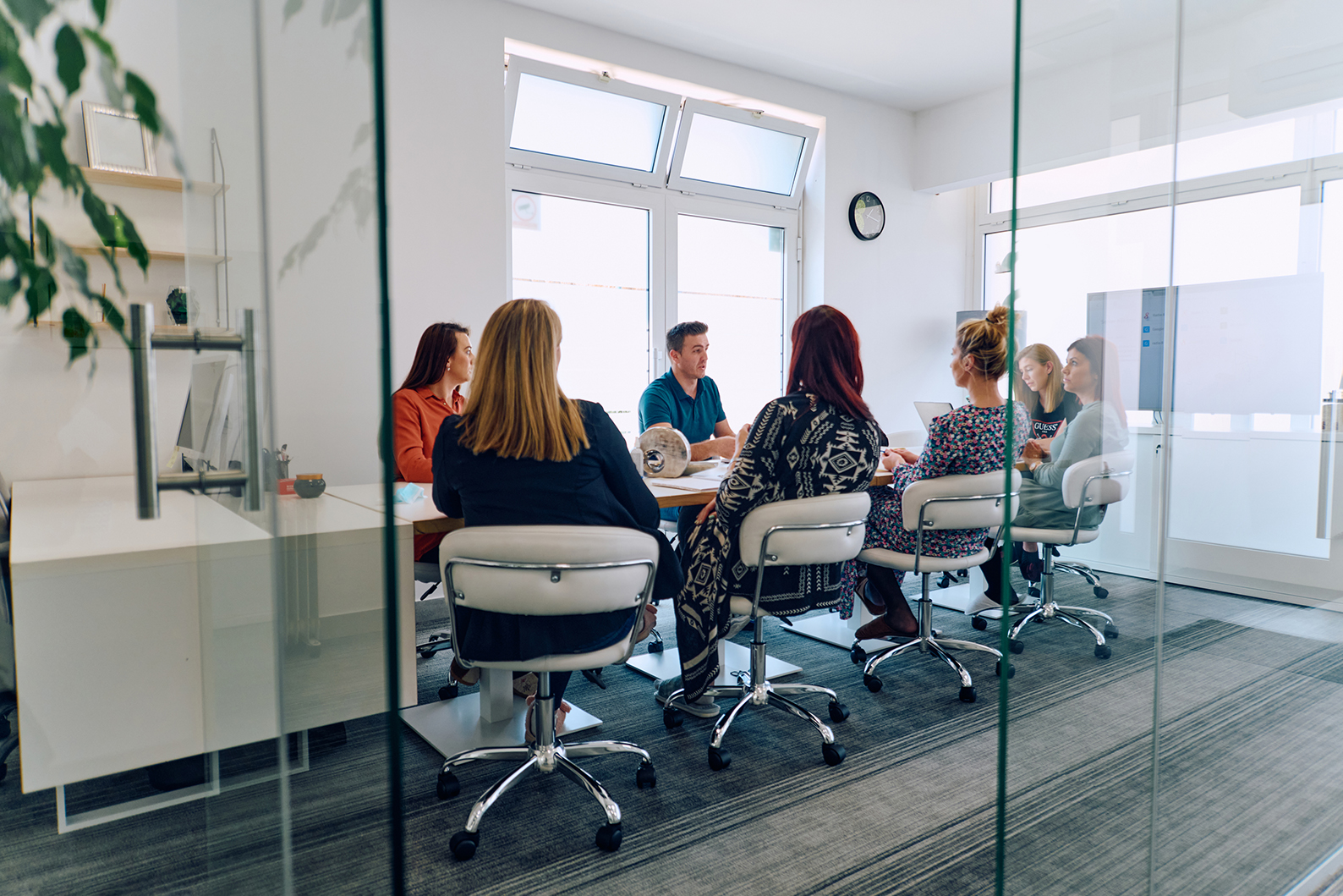 Group of legal professionals conversing around conference table