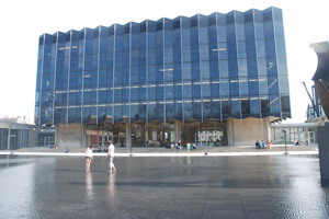 A broad tile walkway leads to the law school--a large, midcentury Modern building with glass walls.