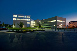 Law school exterior at night. The building is modern and angular.