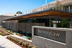 University exterior. Stone sign that says, 'Berkeley Law University of California.'