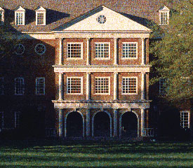 Law school's main entrance. Three arches lead to the doorways on floor one. There are three, large, windows on both the second and third floor. White columns separate the windows and arches.