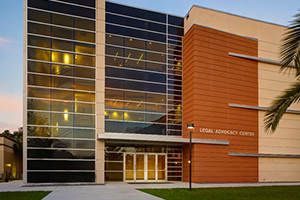 The Legal Advocacy Center—a tall, modern building with many windows.
