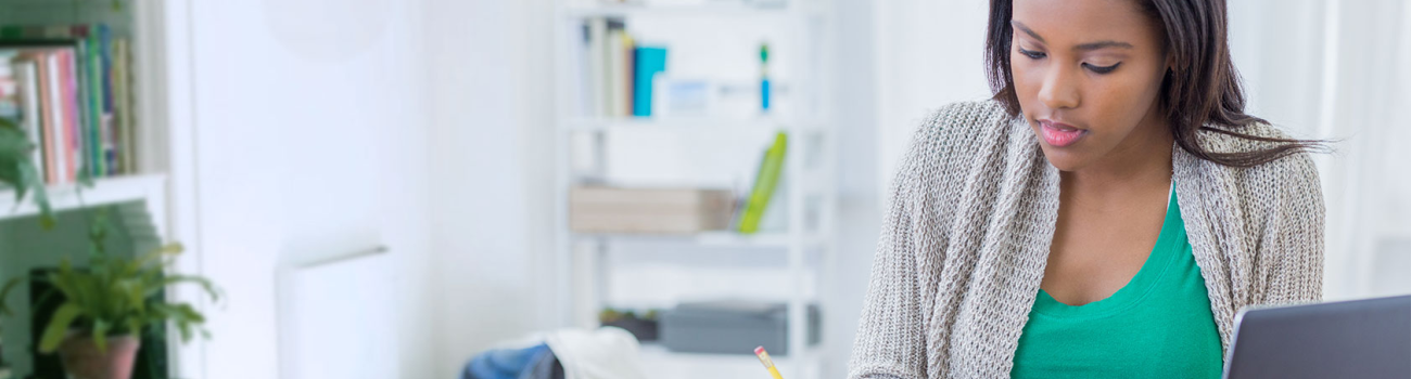 Woman taking notes at desk