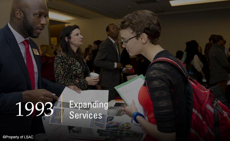 A law school representative shows an academic brochure to a prospective law student at an LSAC Law School Forum. Image copyright LSAC.