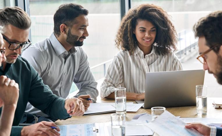 Law students gathered round table with laptops