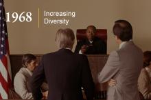 An African American judge presides over a courtroom trial.