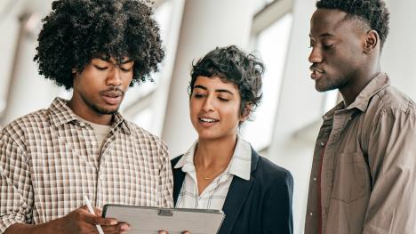 Diverse law students reviewing notes together