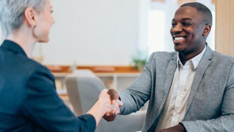Law school graduate shaking hands with potential employer