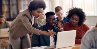 Group of law students gathered around a laptop