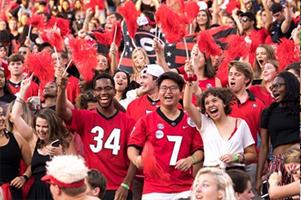 Students cheering at football game.