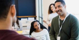 Instructor speaking with students