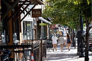 People walking along sidewalk in town