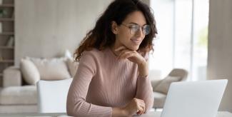 Student at looking at laptop at desk