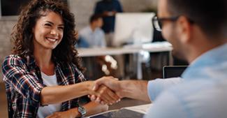 Law student shaking hands with law school representative