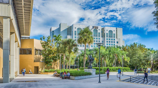 Students shown walking on campus with FIU buildings in the background