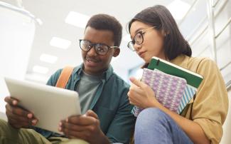 Law students looking at tablet together