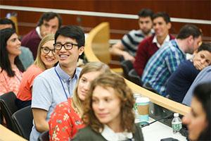 Students smile in a classroom setting