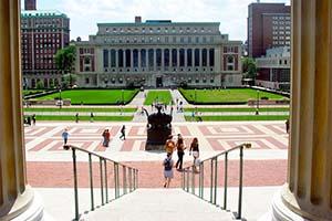 Students descend a staircase that leads into a courtyard