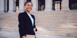 Black woman standing in front of Supreme Court building