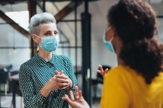 masked person having conversation