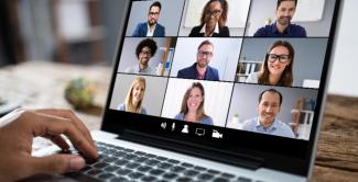 Laptop screen with video conference webinar displayed