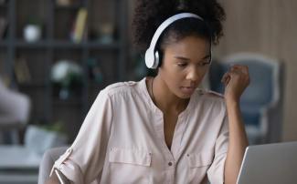 Law student at laptop with headphones