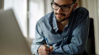 a person researching and writing notes