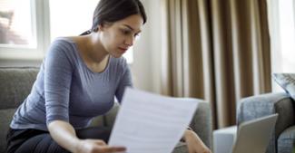 looking through paperwork in a living room setting