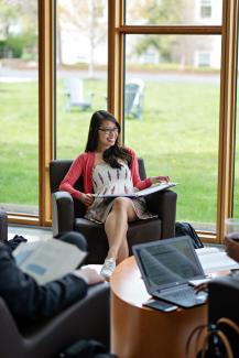 Student reading in lower level commons area