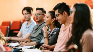Group of students in lecture hall smiling