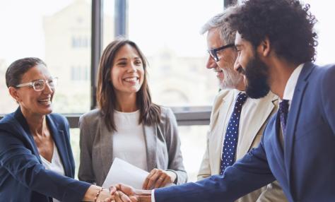 Group of professionals greeting each other