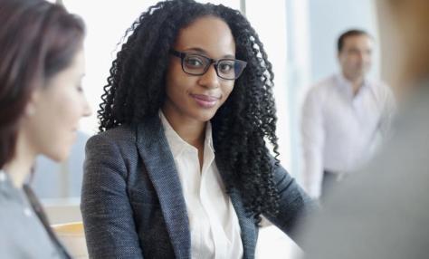 woman with glasses sitting with a group