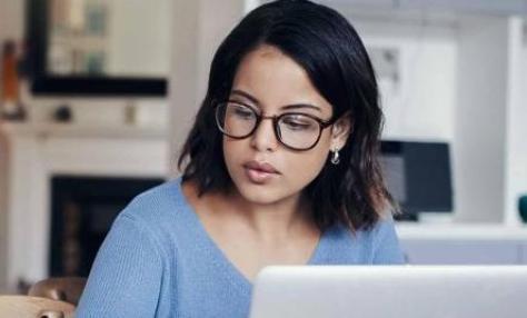 woman with glasses with laptop open