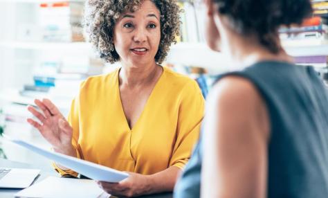 Two women conferring. 