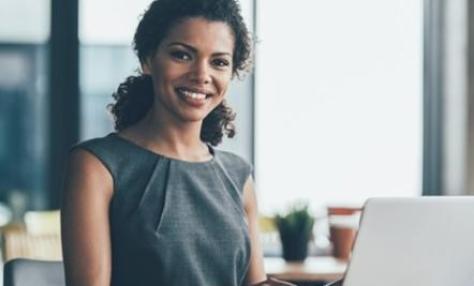 Woman smiling with laptop open 