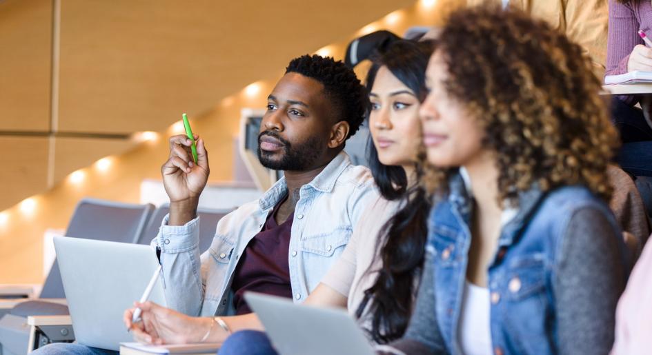 Law students in lecture hall listening.