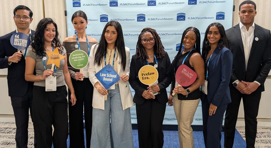 a group of students at a photobooth at the Miami forum