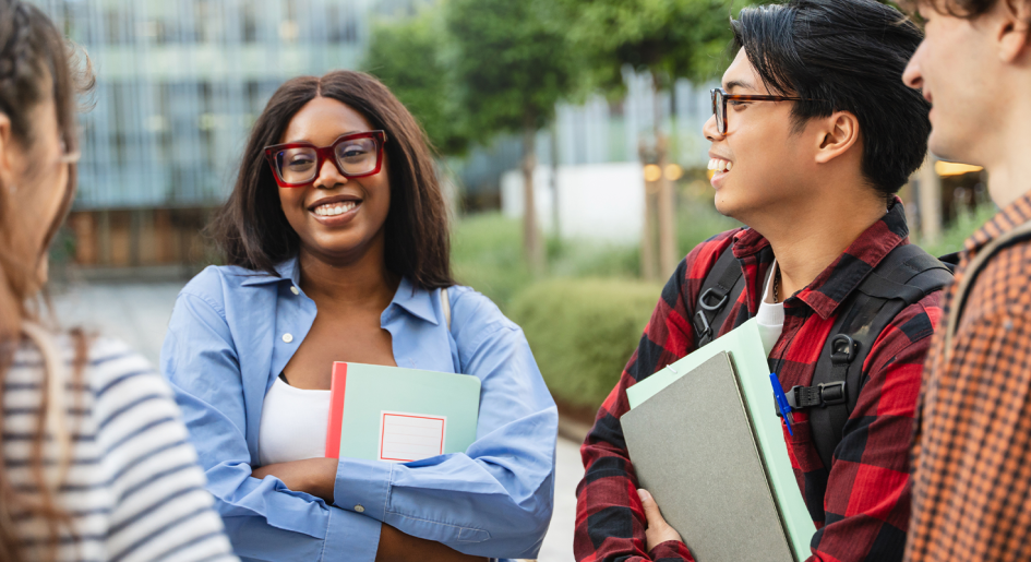 A group of students stands in a group, talking