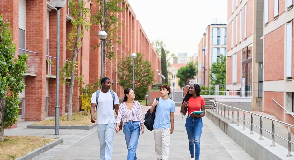 A group of students walk through campus