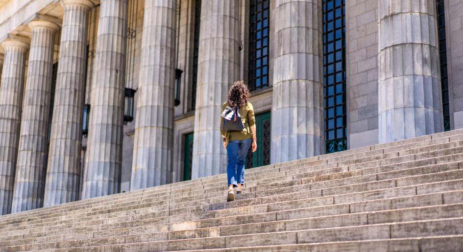 A student walks up courthouse steps