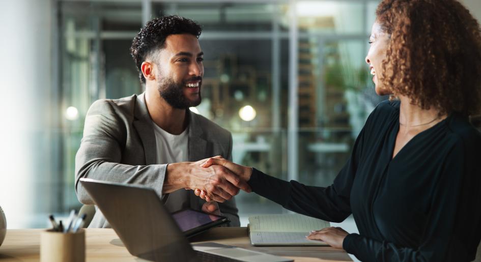 Two people shake hands