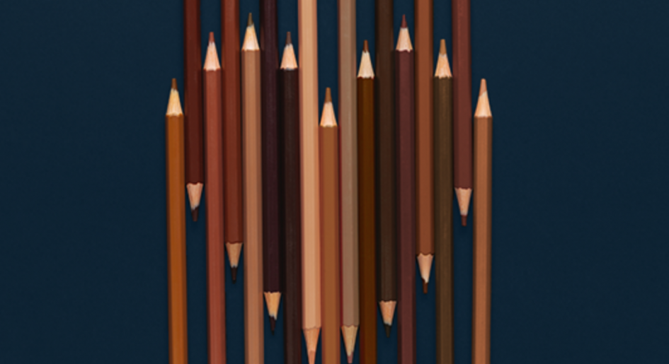 Skin-tone colored pencils form a heart