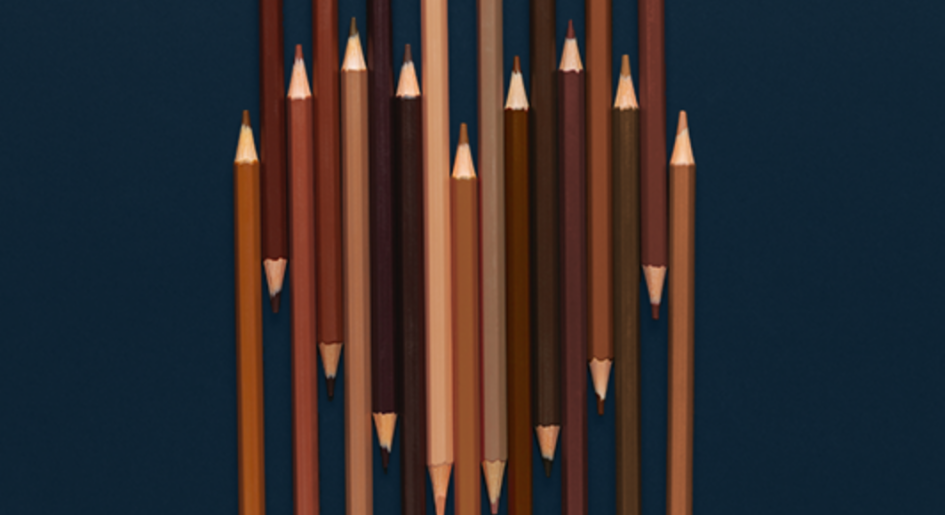 Skin-tone colored pencils form a heart