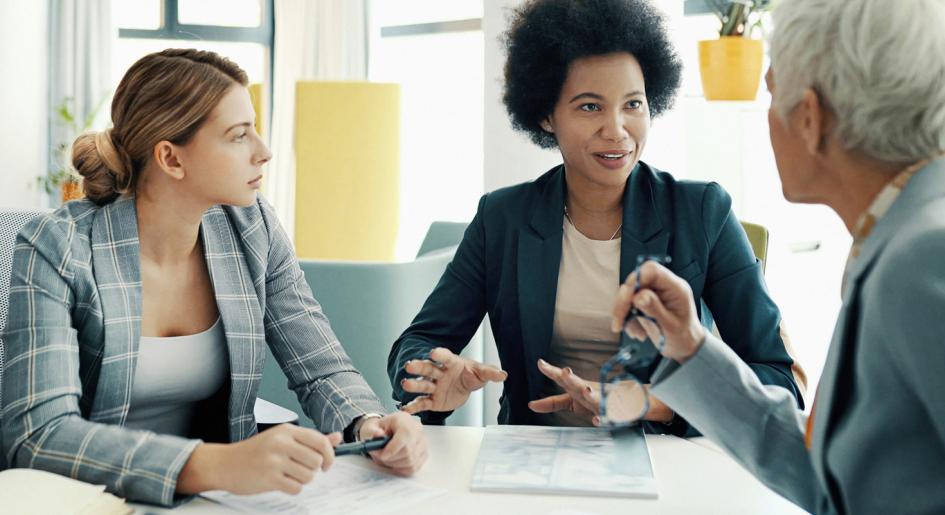 Law school administrators sitting at table conversing