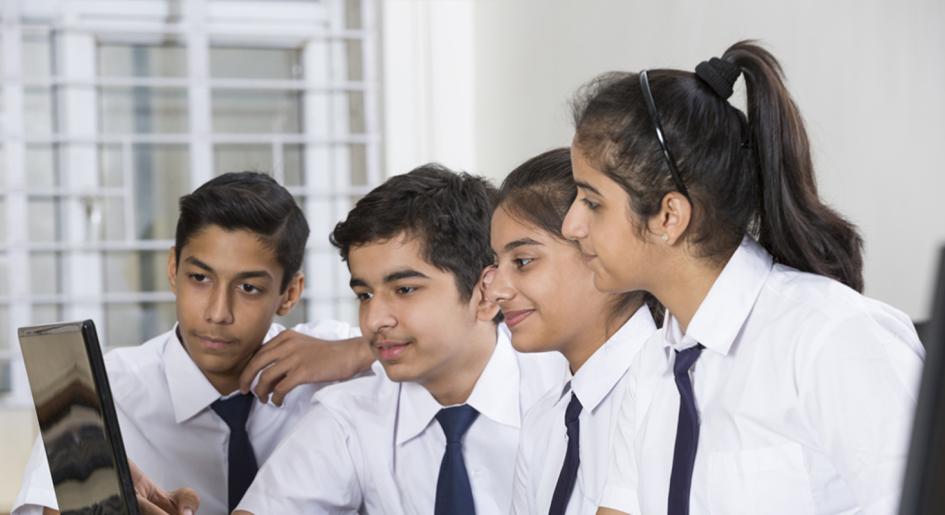 Indian students looking at computer screen