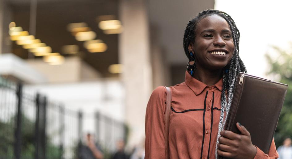 Law student smiling with leather portfolio in hand