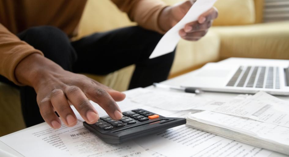 A person types on a calculator