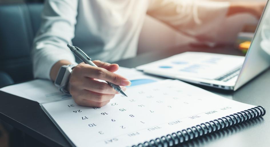 Someone writes on a calendar
